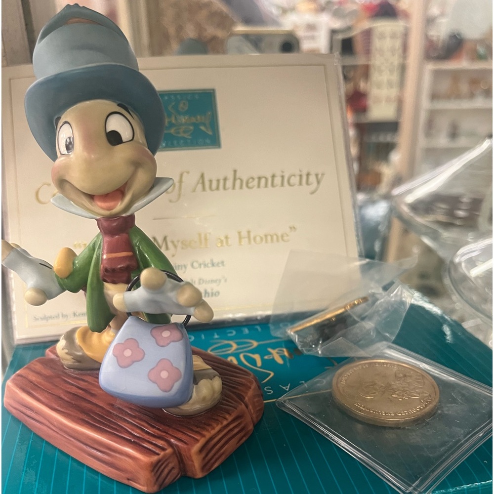 Disney Jiminy, cricket, coin, pin, and certificate, and in new box.